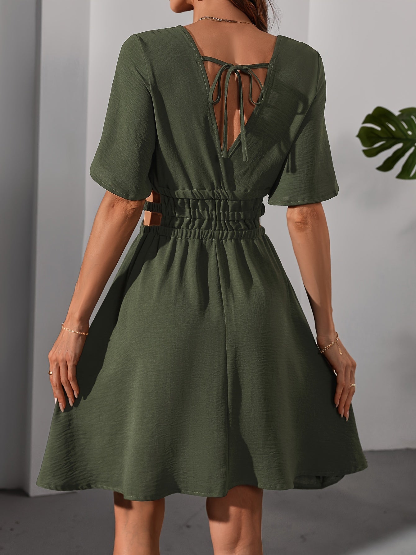 Elegant holiday style women's V-neck dress, military style skirt.